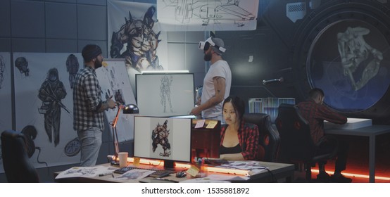 Medium shot of a video game developer team brainstorming - Powered by Shutterstock