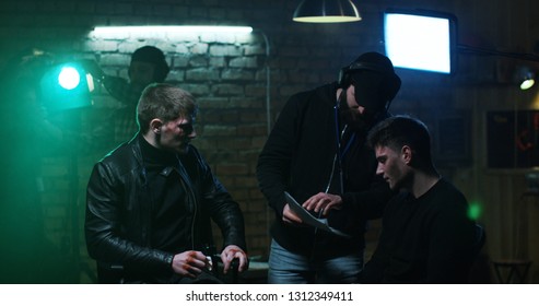 Medium Shot Of Young Director Giving Instructions And Showing The Script To Movie Actors