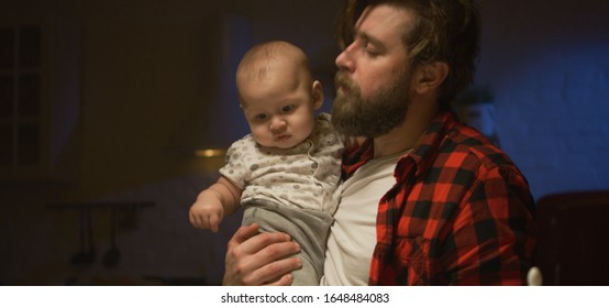 Medium Shot Of A Young Father Feeding His Baby At Night