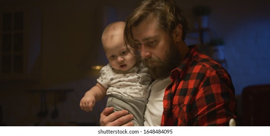 Medium Shot Of A Young Father Feeding His Baby At Night