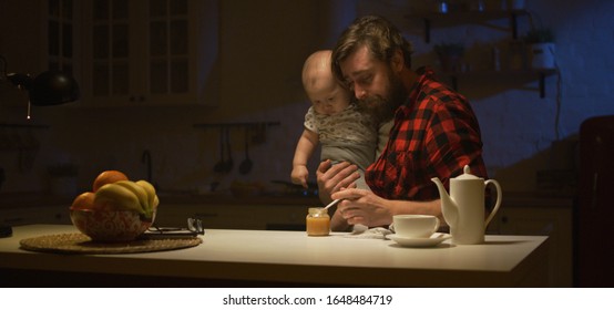 Medium shot of young father replacing mother during nighttime feeding of their baby - Powered by Shutterstock