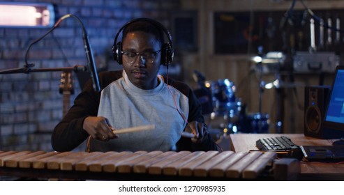 Medium Shot Of Young Marimba Player Recording Music In Home Studio