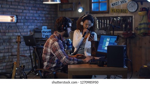 Medium Shot Of Young Musicians Recording Vocal Of Black Singer In Home Studio