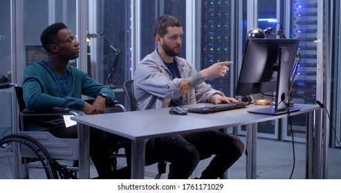 Medium shot of young programmers working in a data center together