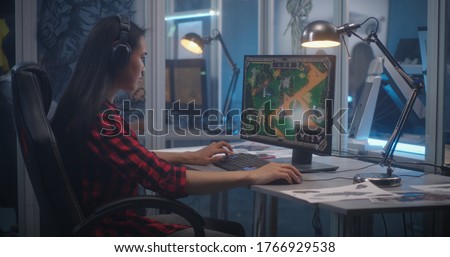 Medium shot of a young woman beta testing video game
