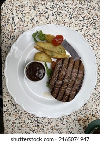 Medium steak with potato wedges and blackpepper sauces