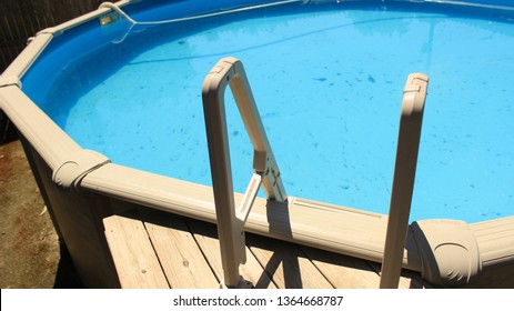 Medium View Of Ladder Leading Down Above Ground Pool