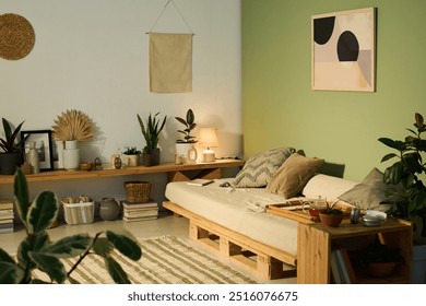 Medium-sized comfortable couch with three cushions and bamboo tray with teapot standing in the corner of spacious living room - Powered by Shutterstock