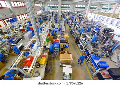MEDOLLA, ITALY-OCTOBER 17, 2012: Factory lines workers assembling medical devices at the Gambro factory, Italian division.