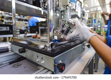 MEDOLLA, ITALY-OCTOBER 17, 2012: Hands With Gloves Assembling A Medical Device On A Factory Line, At The Gambro Factory, Italian Division.