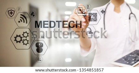 Medtech medical technology information integration internet big data concept on virtual screen. Doctor with stethoscope.