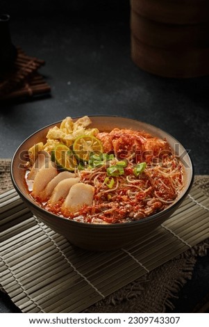 Mee Siam Singapore is a dish of thin rice vermicelli with sour soup on dark background