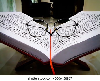 Meerut, India - 12 July 2021: Holy Ramayana Book On Stand With Glasses.