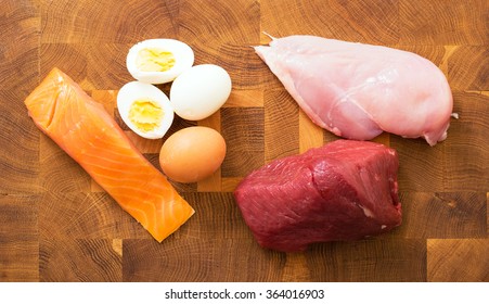 Meet, fish, eggs on kitchen table 