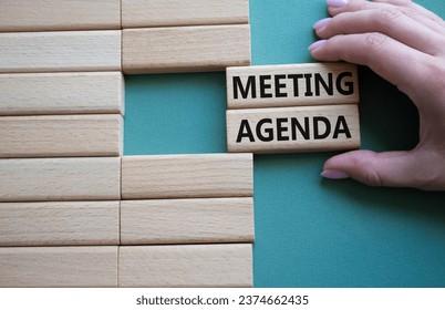 Meeting agenda symbol. Concept word Meeting agenda on wooden blocks. Businessman hand. Beautiful grey green background. Business and Meeting agenda concept. Copy space - Powered by Shutterstock