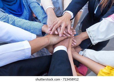 
A Meeting Of Arab And Asian Employees To Work Together As A Team For Success. Hand Of The Group Represents Teamwork. Officer In Company Confident And Work Happy By Agreement Teamwork Leader, Follower