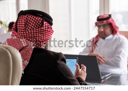meeting between two arabs talking about work details