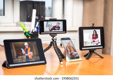 Meeting business in internet. Human Working From Home. Having Online Group Videoconference On gadjets. Online meeting in business of construction company. Meeting of employees of construction company