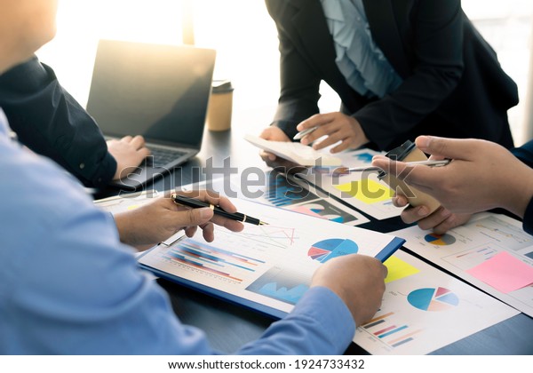 Meeting concept Business team hands at working with\
financial plan, meeting, discussion, brainstorm with tablet on the\
office desk, 