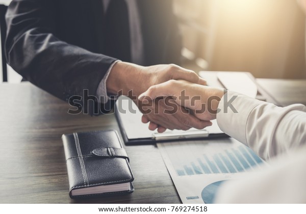 Meeting and greeting concept, Two confident\
Business handshake and business people after discussing good deal\
of Trading contract and new projects for both companies, success,\
partnership, co worker.