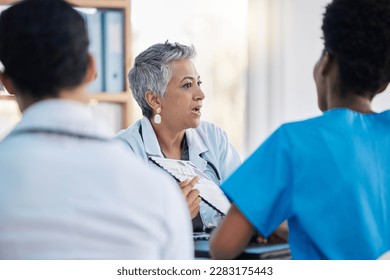 Meeting, hospital and team of doctors with documents for medical strategy, diagnosis and treatment. Healthcare, teamwork and group of health workers in discussion for insurance, planning and surgery - Powered by Shutterstock