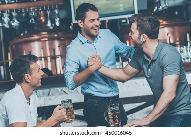 Meeting Old Friends. Three Cheerful Friends Meet Each Other In Beer Pub