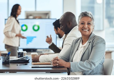 Meeting, portrait or senior business woman planning a sales project with a team in a corporate office. Smile, data analysis or happy mature manager working on strategy in collaboration with people - Powered by Shutterstock