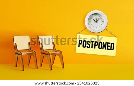 Meeting postponed is shown using the text and photo of clock. Postponed concept for business meeting