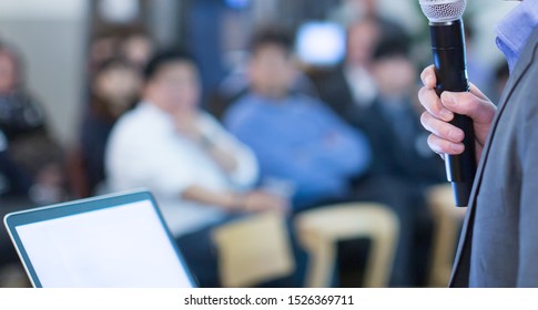 Meeting Presenter. Conference With Business People Training And Learning. Coaching Concept With Blurred Background. Speaker Talking To Audience In Hall During Seminar Event. Lecture Series Speech.
