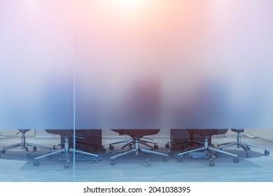 Meeting room in a modern office, with blurred glass partitions and movable chairs - Shutterstock ID 2041038395