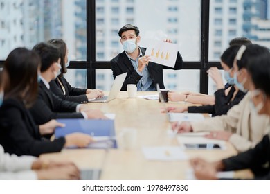 In A Meeting Room, A Sales Manager Is Discussing Sales Forecast With His Team.