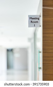 Meeting Room Sign On The Glass Door Inside An Office Building.