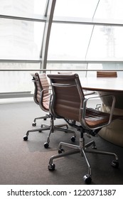 Meeting Room With Table And Chairs For Collaboration Lit By Natural Light From A Nearby Window, Blank Empty With Nobody Modern Office Fitout