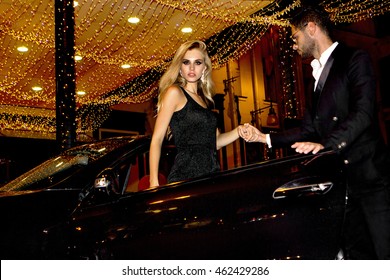 Meeting Stars On The Red Carpet. Couple In Luxury Car. Night Life.