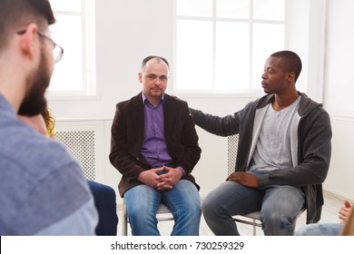 Meeting of support group. Depressed man sitting at rehab group therapy. Psychotherapy, depression, life issues concept