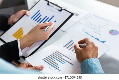 Meeting a team of businessmen, Executives and accountants meeting about the company's revenue graph in the office with laptops and calculators, Finance concept.
