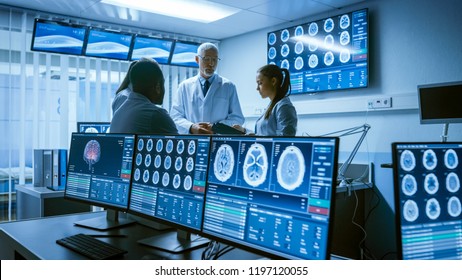 Meeting of the Team of Medical Scientists in the Brain Research Laboratory. Neurologists / Neuroscientists Having Analytical Discussion Surrounded by Monitors Showing CT, MRI Scans.