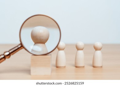 meeting, teamwork, worker, resource, search, talent, ceo, diversity, employer, executive. A magnifying glass is looking at wooden figures. The figures are all the same size and are arranged in a row. - Powered by Shutterstock