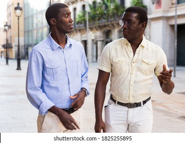 Meeting of two african american men on a city street