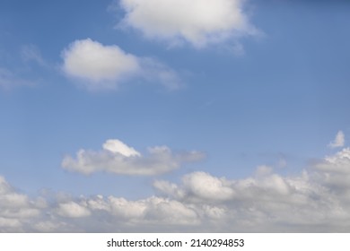 Meeting Of Two Angelic White And Fluffy Clouds With Menacing Gray-white Dense Cumulus Clouds On A White-blue Soft Morning Sky