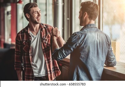 Meeting Of Two Handsome Male Friends In Bar.