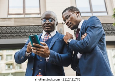 Meeting of two partners black african american businessman in suits and glasses outdoors