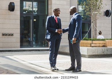 Meeting Of Two Partners Black African American Businessman In Suits And Glasses Outdoors. Friendship And Business Partnership