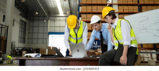 Meeting at warehouse concept.Warehouse managers and worker talking in a large warehouse.business manager and worker discussing with computer.Transportation and logistic network distribution growth - Powered by Shutterstock