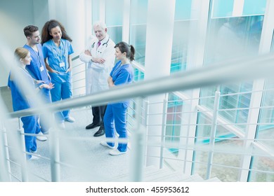 Meeting Of Young Interns With Their Supervisor At The Hospital Stairs