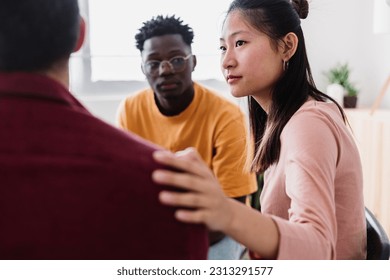 Meeting of young people in group therapy supporting each other at community center. Help and support concept. - Powered by Shutterstock