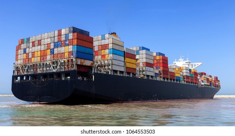 Mega Container Ship Entering A Commercial Port