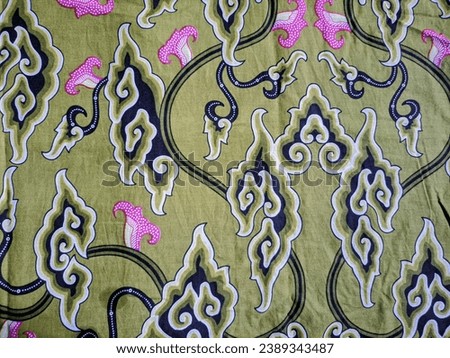 Mega mendung motif batik cloth with dominant colors of dark green and pink makes it more artistic
