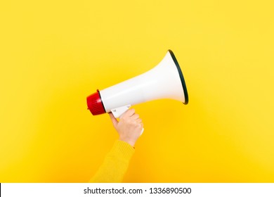 Megaphone In Hand On A Yellow Background, Attention Concept Announcement