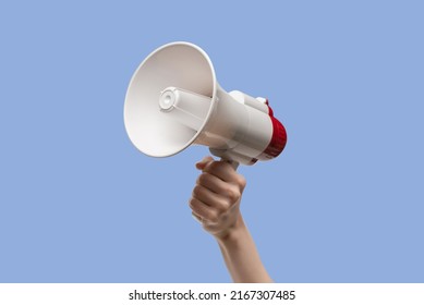 Megaphone in woman hands on a white background.  Copy space.  - Shutterstock ID 2167307485